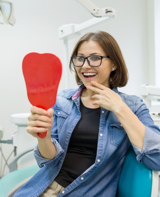 Woman looking at her restored smile