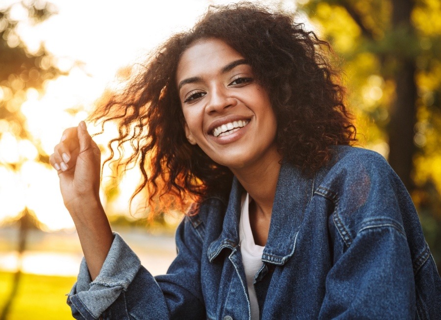 Woman with healthy smile after dental checkup and teeth cleaning