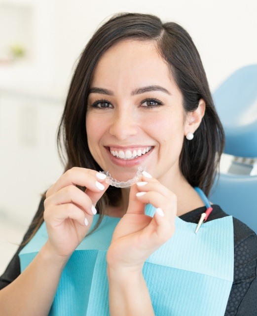 woman in dental chair placing an Clear Correct aligner