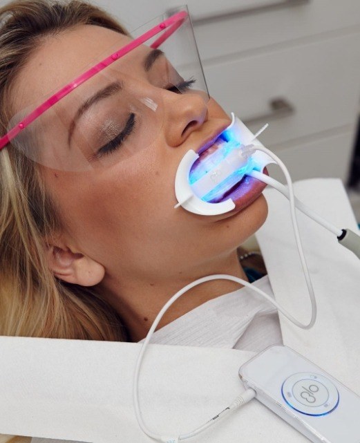 Patient receiving GlO teeth whitening treatment