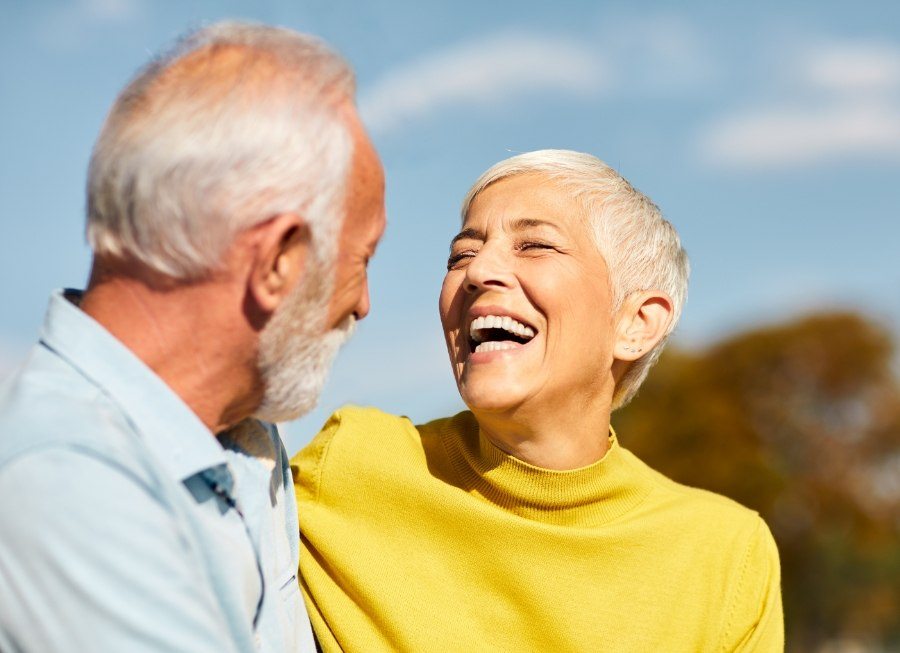 Man and woman smiling together after visiting their Delta dental dentist