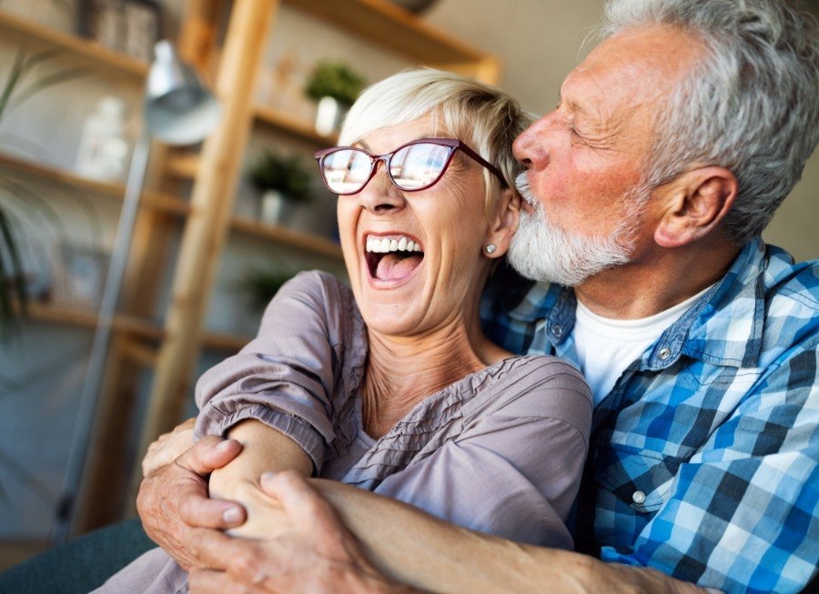 Man and woman with dentures smiling together