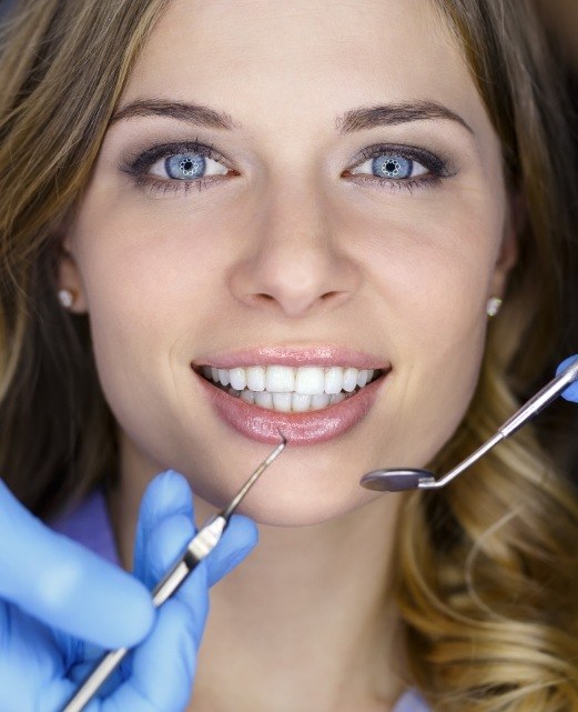 Dentist examining dental patient to prevent dental emergencies