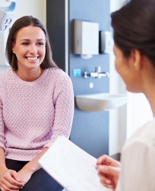 Woman smiling while visiting Dooley Dental