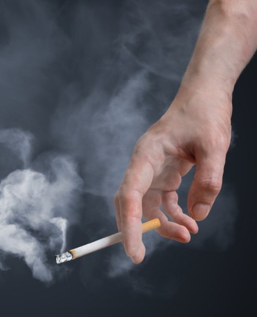 Person holding a cigarette tobacco use is a risk factor for oral cancer