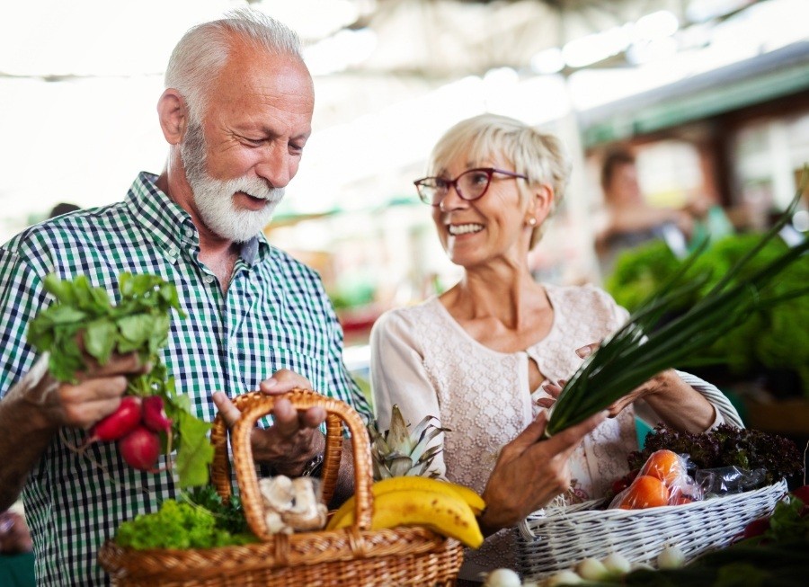 Man and woman shopping at the farmer's market after visiting the dentist in Sea Girt