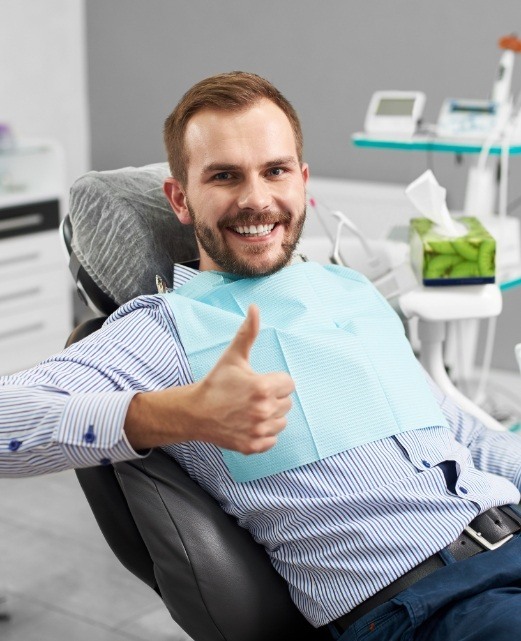 Man giving thumbs up after dental visit