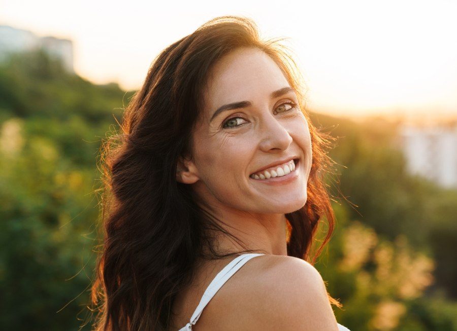 Woman with porcelain veneers smiling