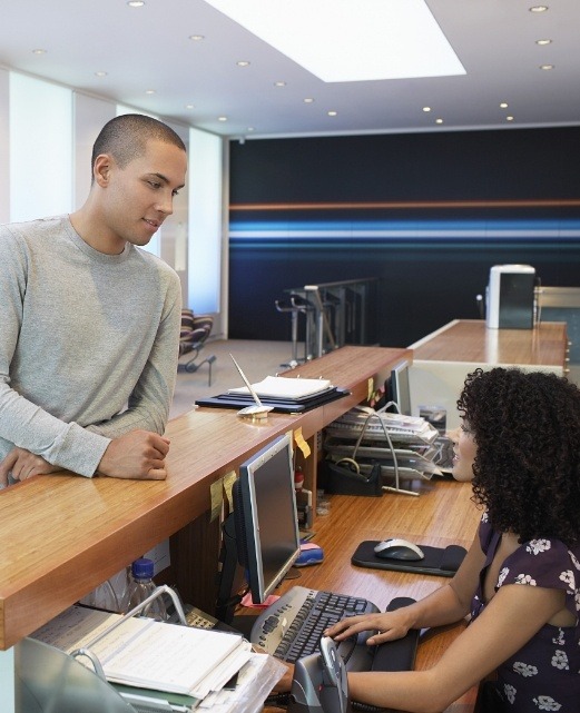 Man check-in in at dental office reception desk