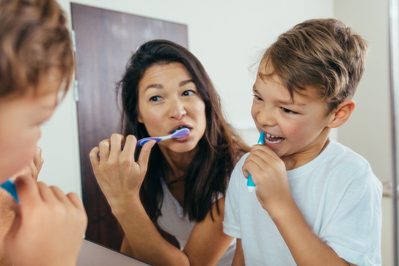 Mother and daughter brushing teeth ahead of their spring cleaning