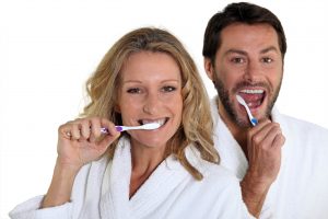 couple brushing teeth