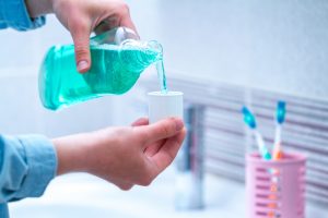 Dentist in Spring Lake pours mouthwash 