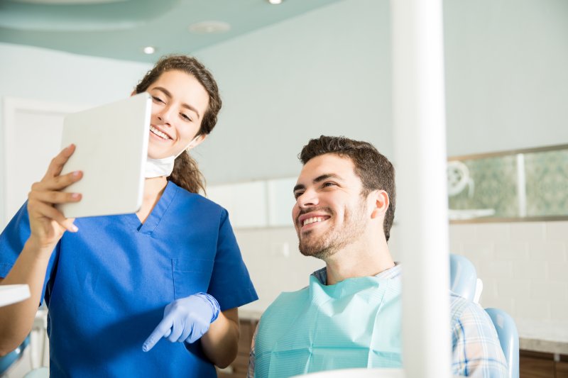 Patient talking to dentist at dental appointment